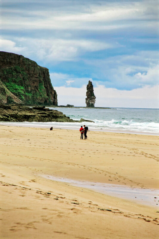 A Couple Walking On The Beach At Sandwood Bay