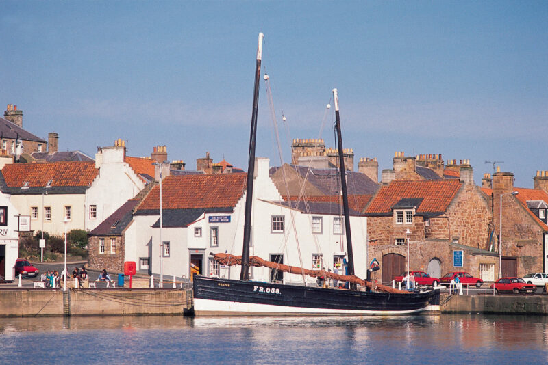 Looking Across The Harbour At Anstruther To A Moored Sailing Boat The Scottish Fisheries Museum Behind Fife
